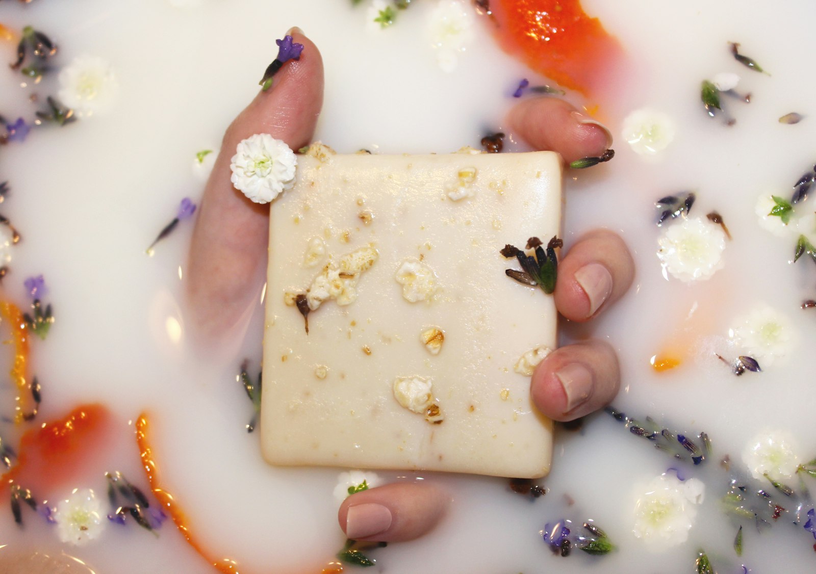 Shampoo bars resting on a well-draining wooden soap dish
